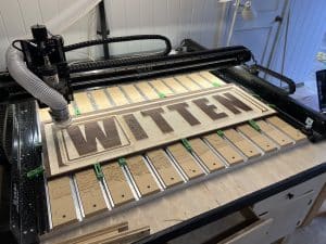 CNC Services Across Alabama Wood Shoppe 2.0’s main CNC cutting a wooden sign for a baby’s room.
